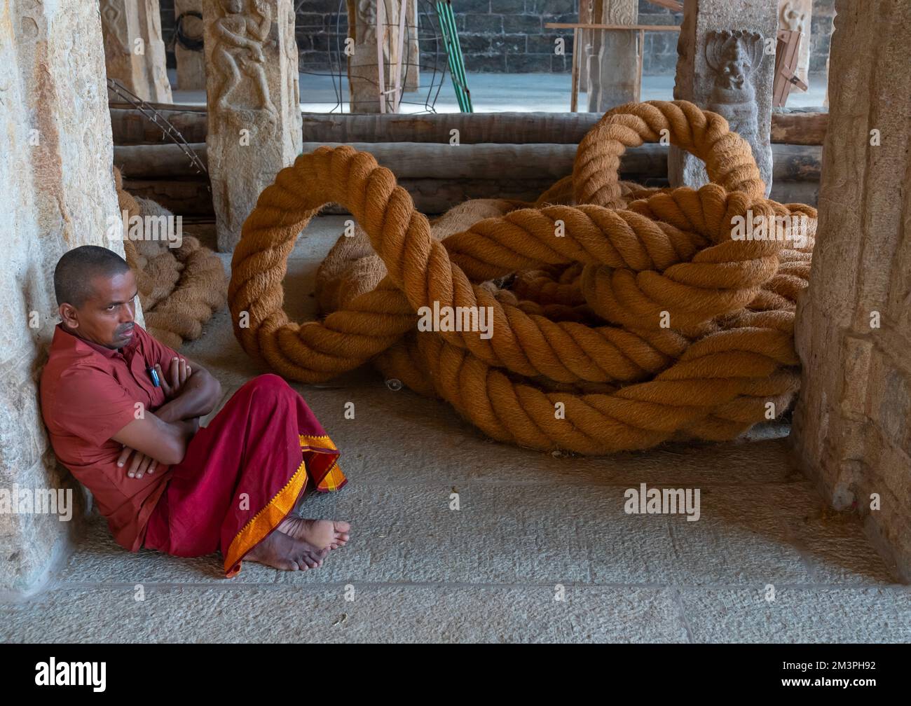 Indian sit near a huge rope in Sri Ranganathaswamy Temple, Tamil Nadu
