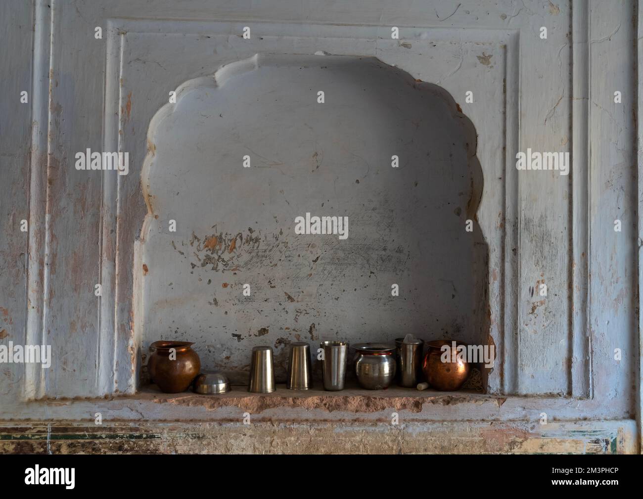 Steel cups in a niche inside Galtaji temple, Rajasthan, Jaipur, India Stock Photo
