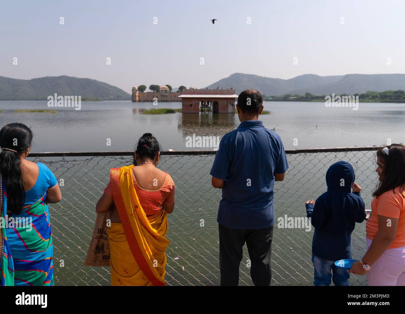 Indian tourists in front of Jal mahal water palace on Man Sagar lake, Rajasthan, Jaipur, India Stock Photo