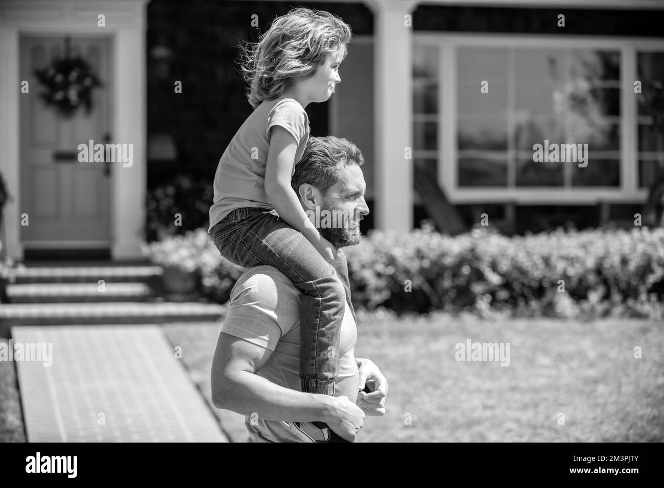 happy father carry son near house. family value. childhood and parenthood. Stock Photo