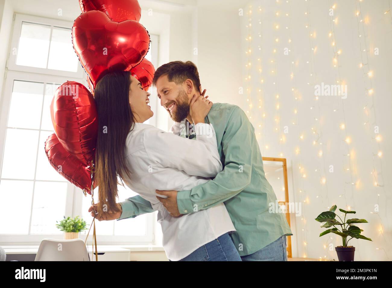 Happy, cheerful couple in love celebrating Valentine's Day, hugging ...