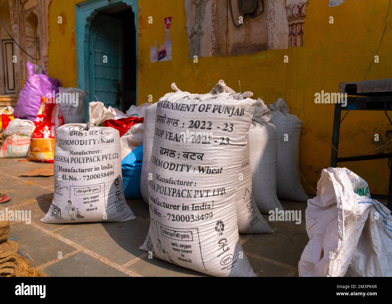 Bags of wheat in front of a store, Rajasthan, Mahansar, India Stock Photo
