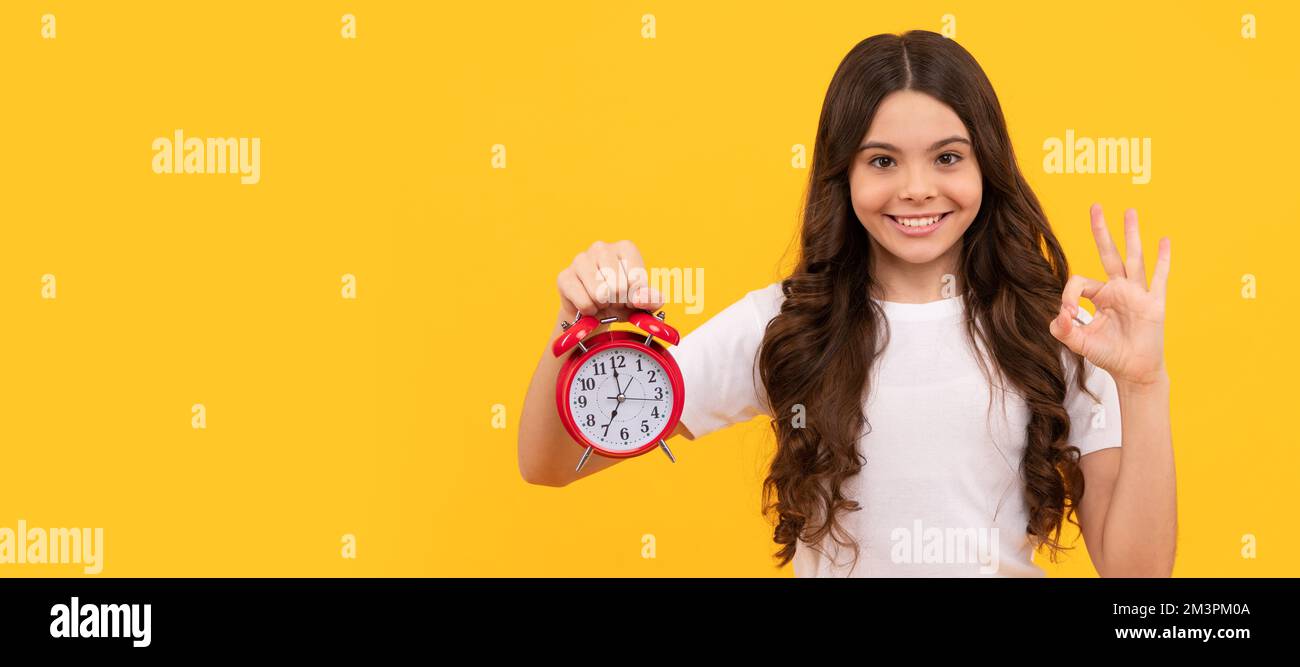 punctuality. happy kid hold alarm clock. last chance. time for shopping sales. good morning. Teenager child with clock alarm, horizontal poster Stock Photo