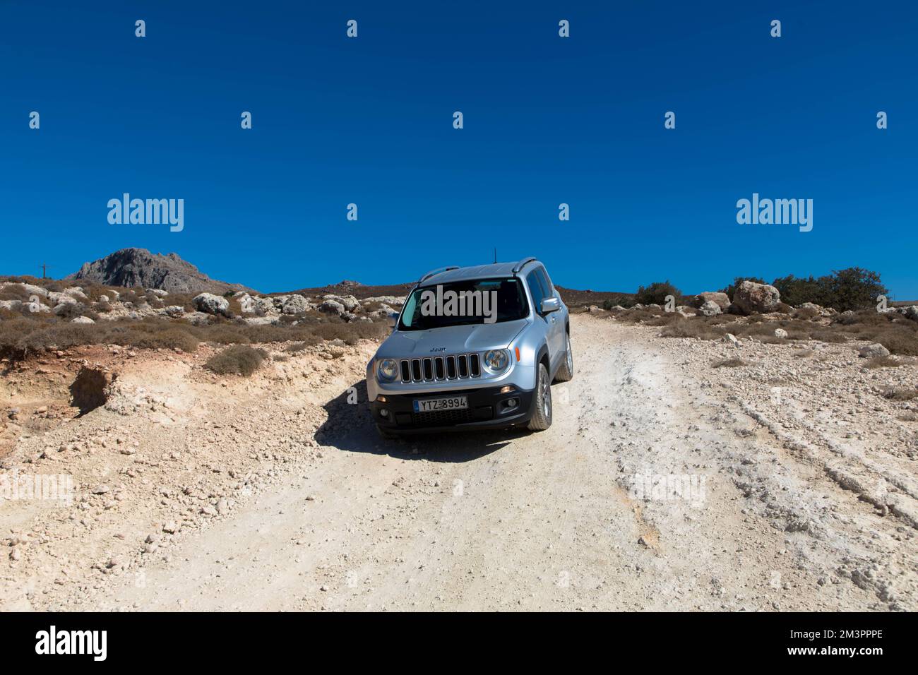 Vacation with a rental car. 4x4 off-road Jeep Renegade on dirt road on Rhodes island. Greece. October 09, 2022 Stock Photo