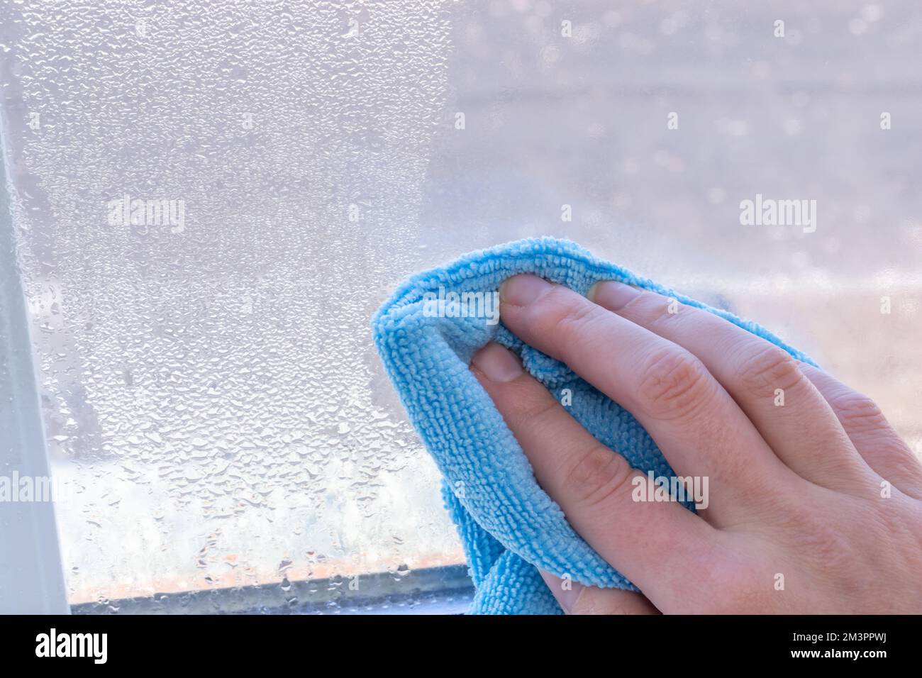 Condensation on windows in winter, wiping with a dry cloth Stock Photo Alamy