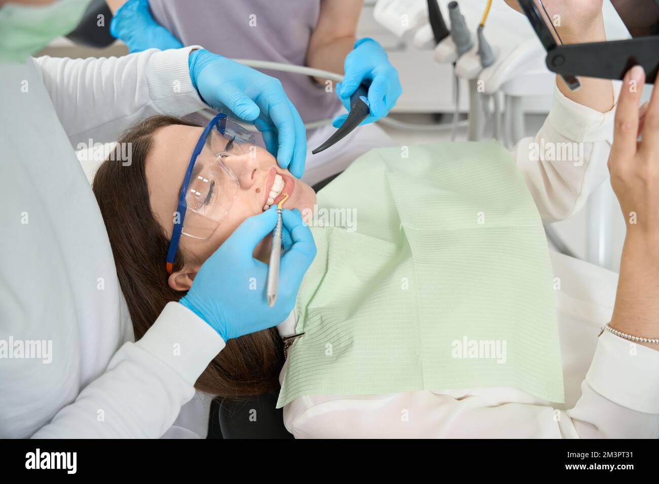 female-undergoing-interdental-cleaning-procedure-performed-by-dental