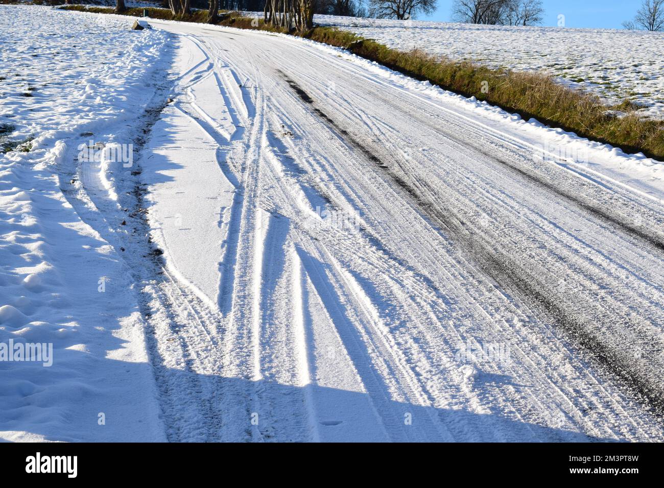 tire tracks in deep snow leading up the hill Stock Photo - Alamy