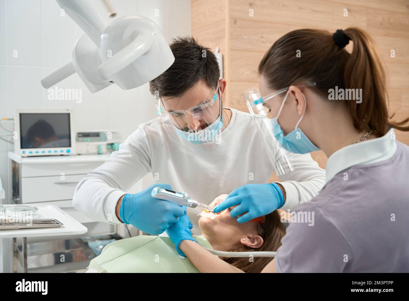 Professional dentist injecting anesthetic to patient gum before procedure Stock Photo Alamy
