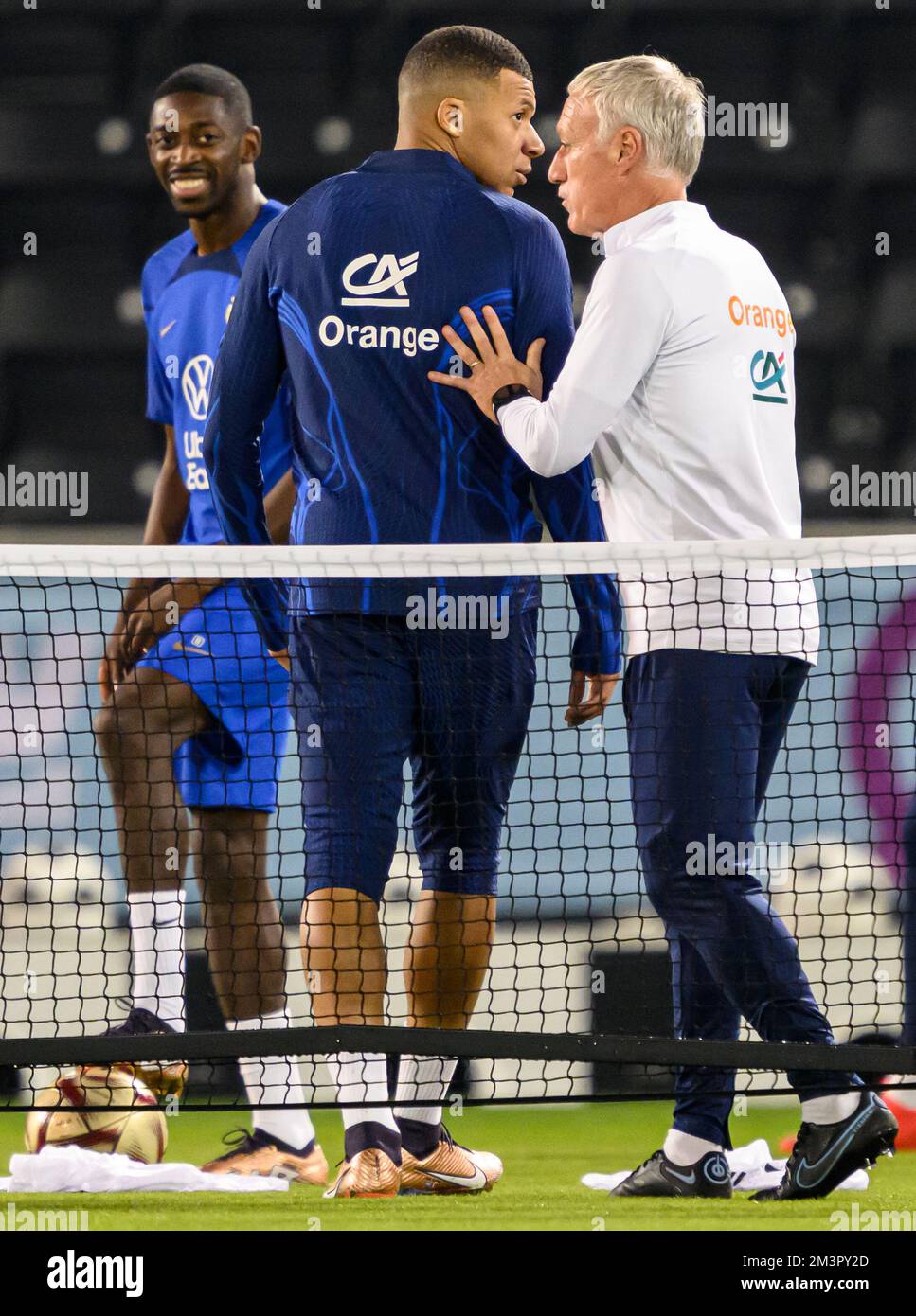 Doha, Qatar. 16th Dec, 2022. Soccer: World Cup, Before the final Argentina - France, press conference France at Al Sadd SC stadium. France coach Didier Deschamps (r) talks to Kylian Mbappe (M). Credit: Robert Michael/dpa - IMPORTANT NOTE: In accordance with the requirements of the DFL Deutsche Fußball Liga and the DFB Deutscher Fußball-Bund, it is prohibited to use or have used photographs taken in the stadium and/or of the match in the form of sequence pictures and/or video-like photo series./dpa/Alamy Live News Stock Photo