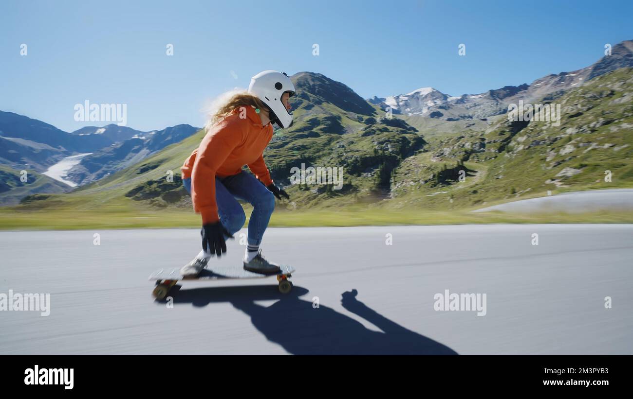 Cinematic downhill longboard session. Young woman skateboarding and making  tricks between the curves on a mountain pass. Concept about extreme sports  Stock Photo - Alamy