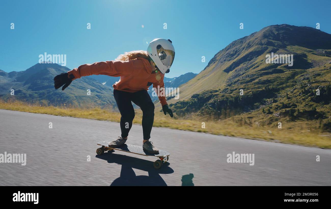 Cinematic downhill longboard session. Young woman skateboarding and making  tricks between the curves on a mountain pass. Concept about extreme sports  Stock Photo - Alamy