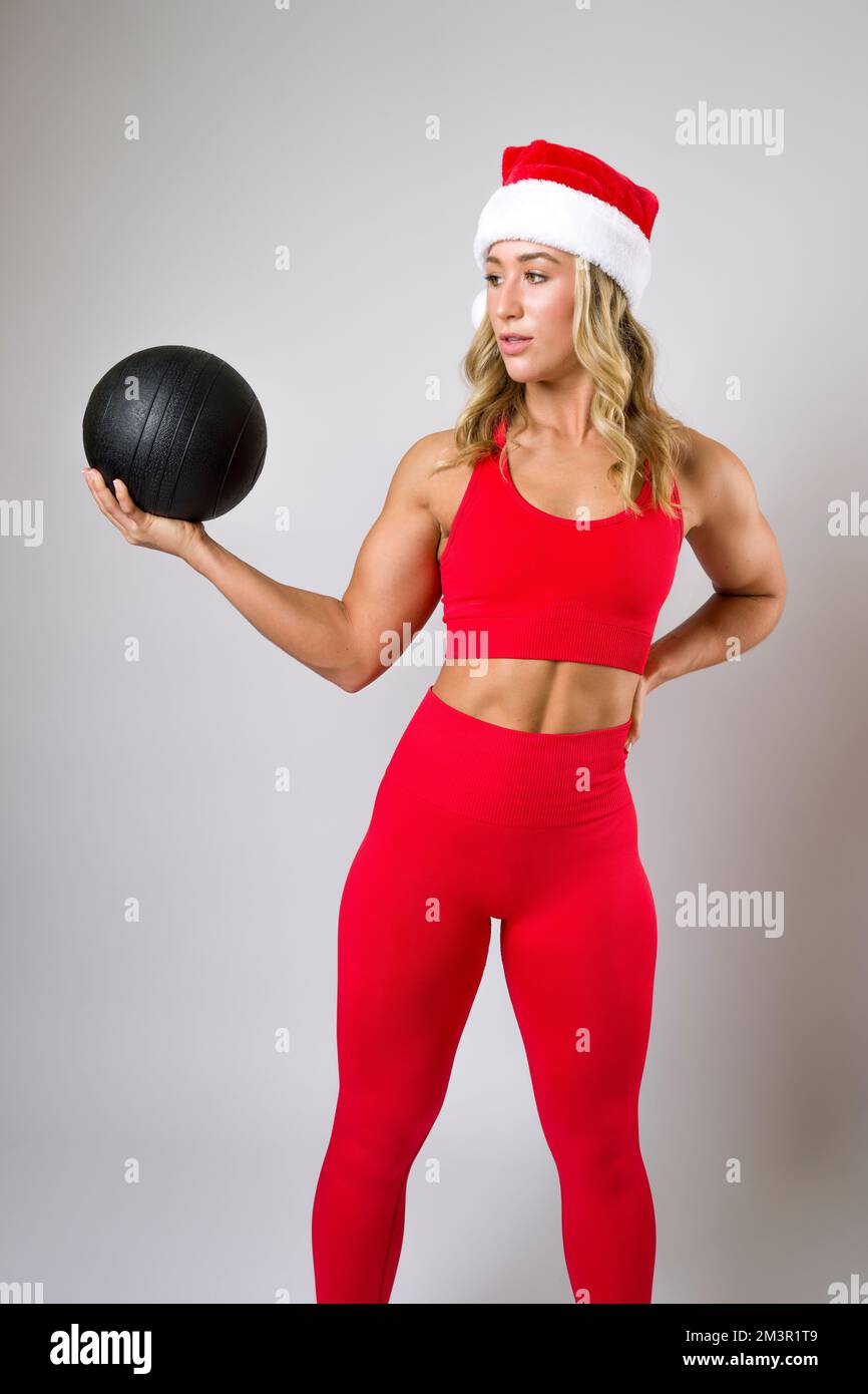 Fit Young Woman in Christmas Holiday Outfit Medicine Ball Workout Stock Photo