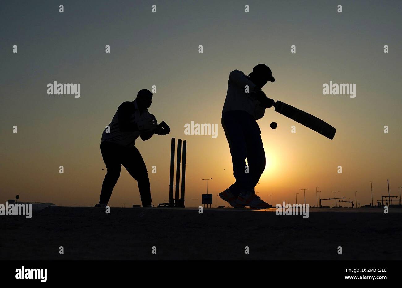 Locals play cricket near the Al Wakrah Sports Training Ground in Qatar