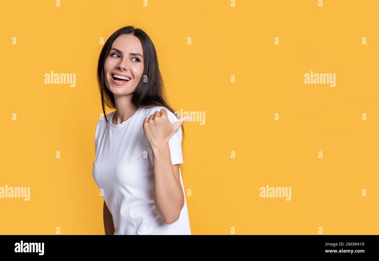 Happy girl pointing thumb hi-res stock photography and images - Alamy