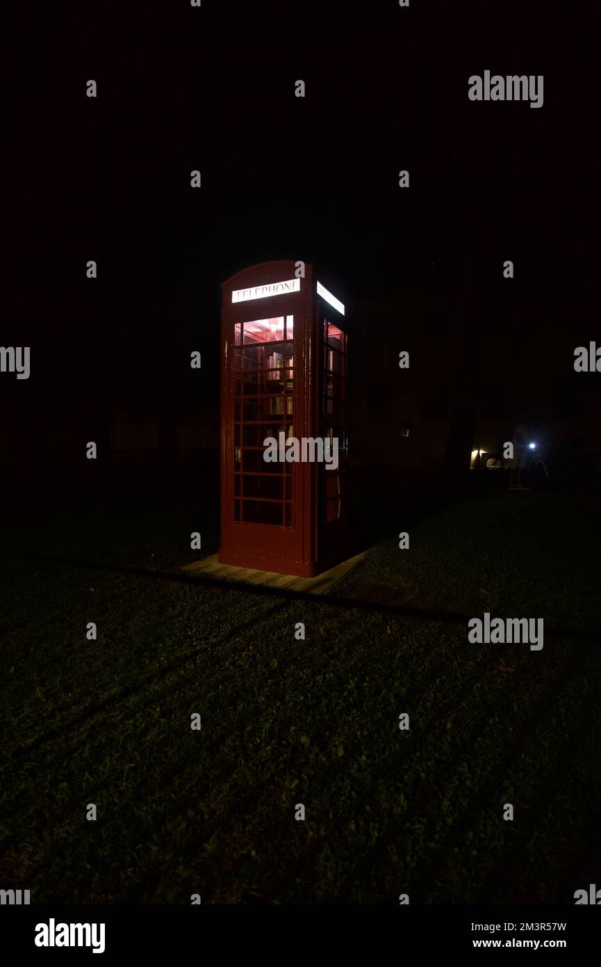 Old english phone booth in a garden Stock Photo - Alamy