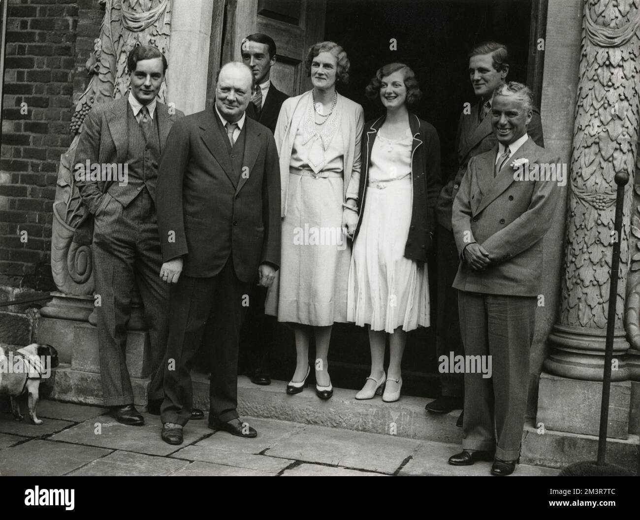 Charlie Chaplin was the guest of Mr and Mrs Winston Churchill at Chartwell, their Westerham, Kent, home for the weekend on 19th September 1931. The photo shows Charlie Chaplin (far right) with his hosts and their daughter (Diana, third from right) and son (Randolph, second from right) and other guests. Clementine Churchill is the central figure.     Date: 1931 Stock Photo