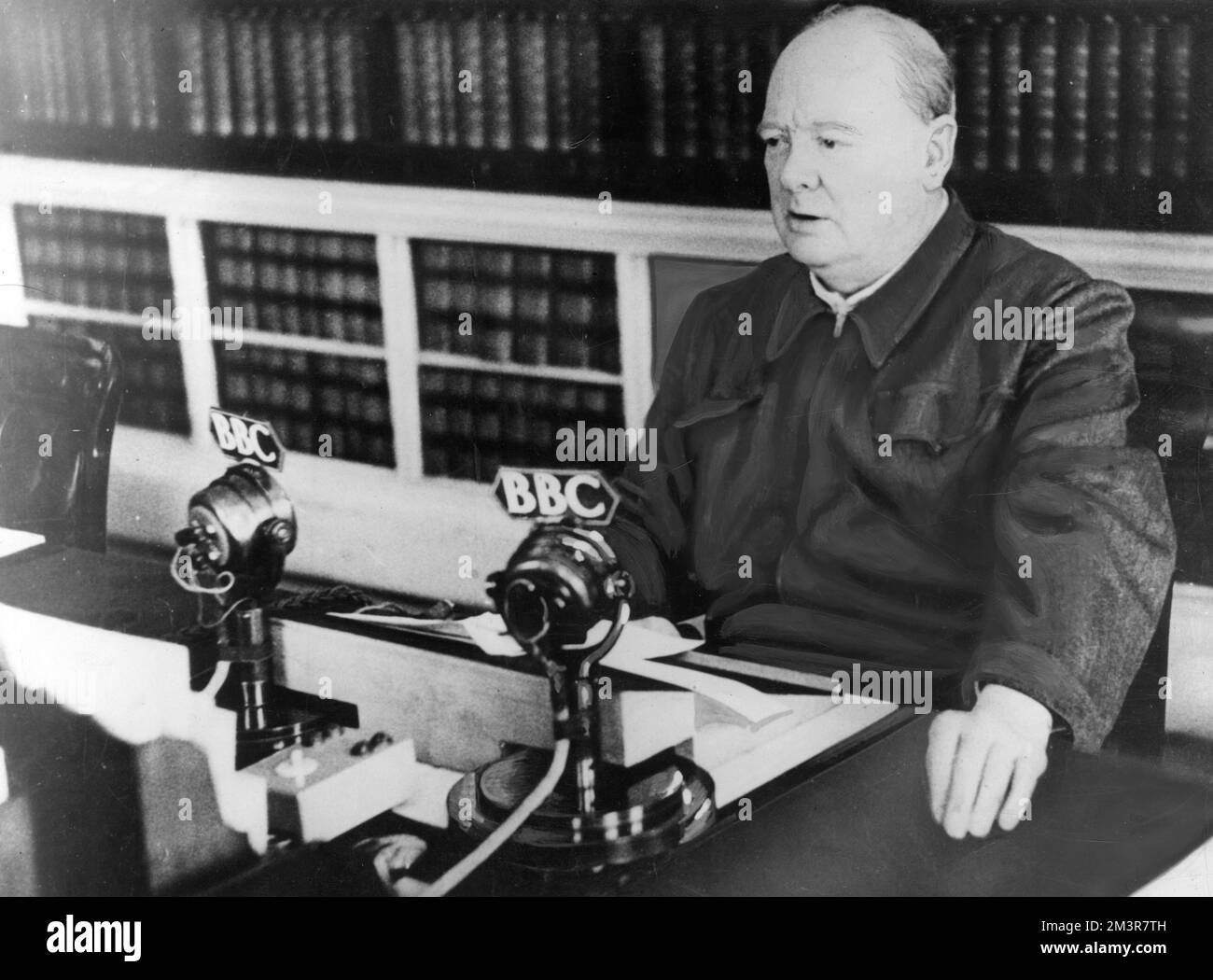Winston Churchill in a BBC radio broadcast in 1940. The back of the photograph states he is, &quot;the broadcaster whose voice inspired the civilised world. He is at the microphone before one of his war reviews relayed to the Empire and America.&quot;     Date: 1940 Stock Photo