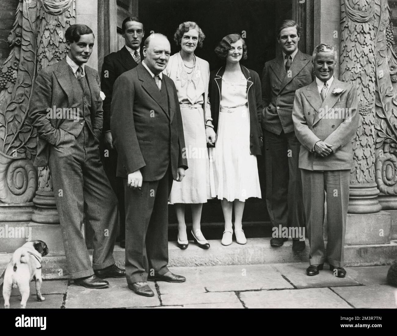 Charlie Chaplin (far right) with Mr and Mrs Winston Churchill and members of a house party at Chartwell Manor, Churchill's Westerham estate in Kent, 19th September 1931. Churchill is in the front row, third figure from left; Clementine Churchill is fourth from left; their eldest daughter Diana Churchill is third from right; their son Randolph is second from right.     Date: 1931 Stock Photo