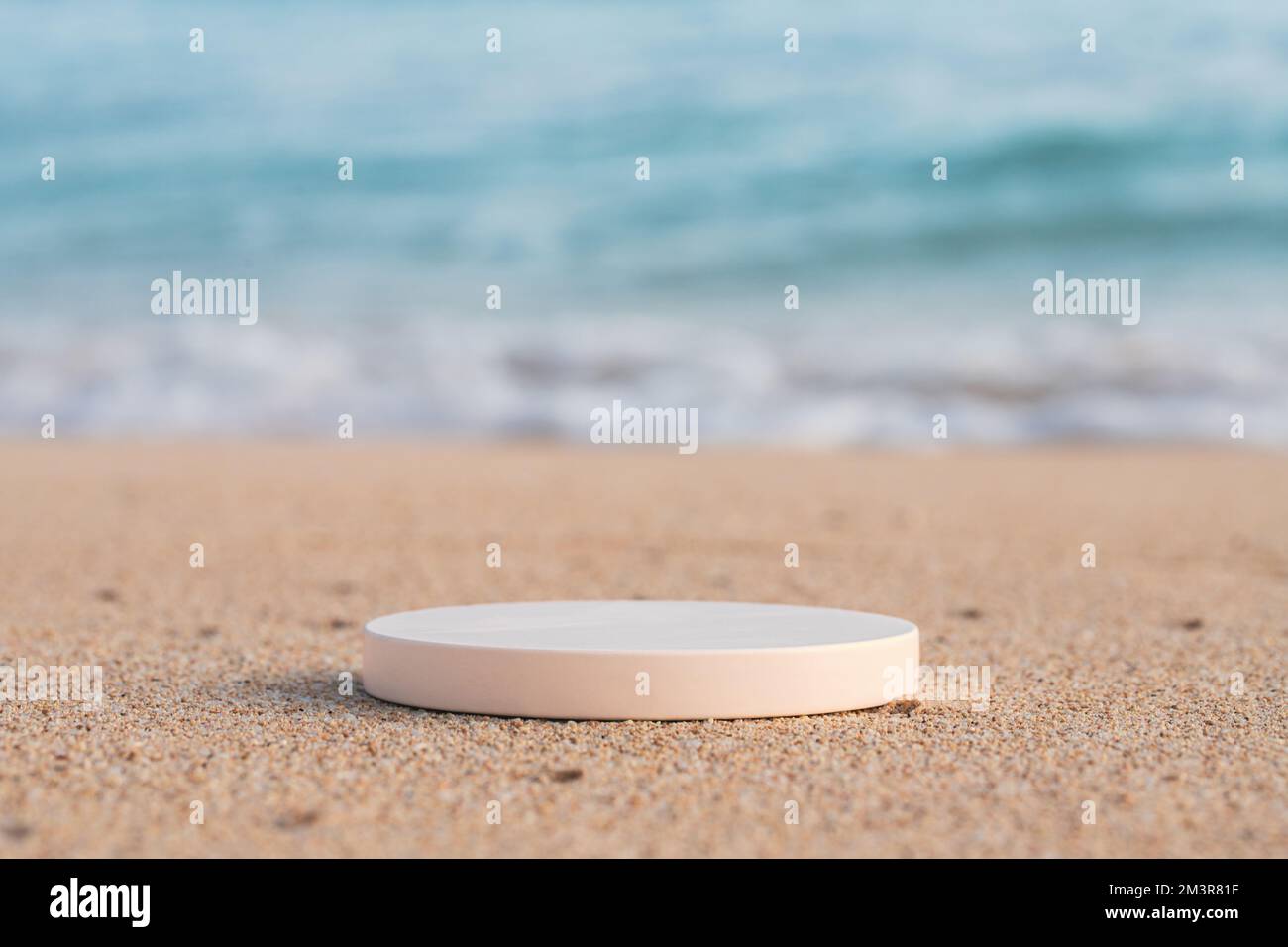 Empty round white platform podium on the beach Stock Photo