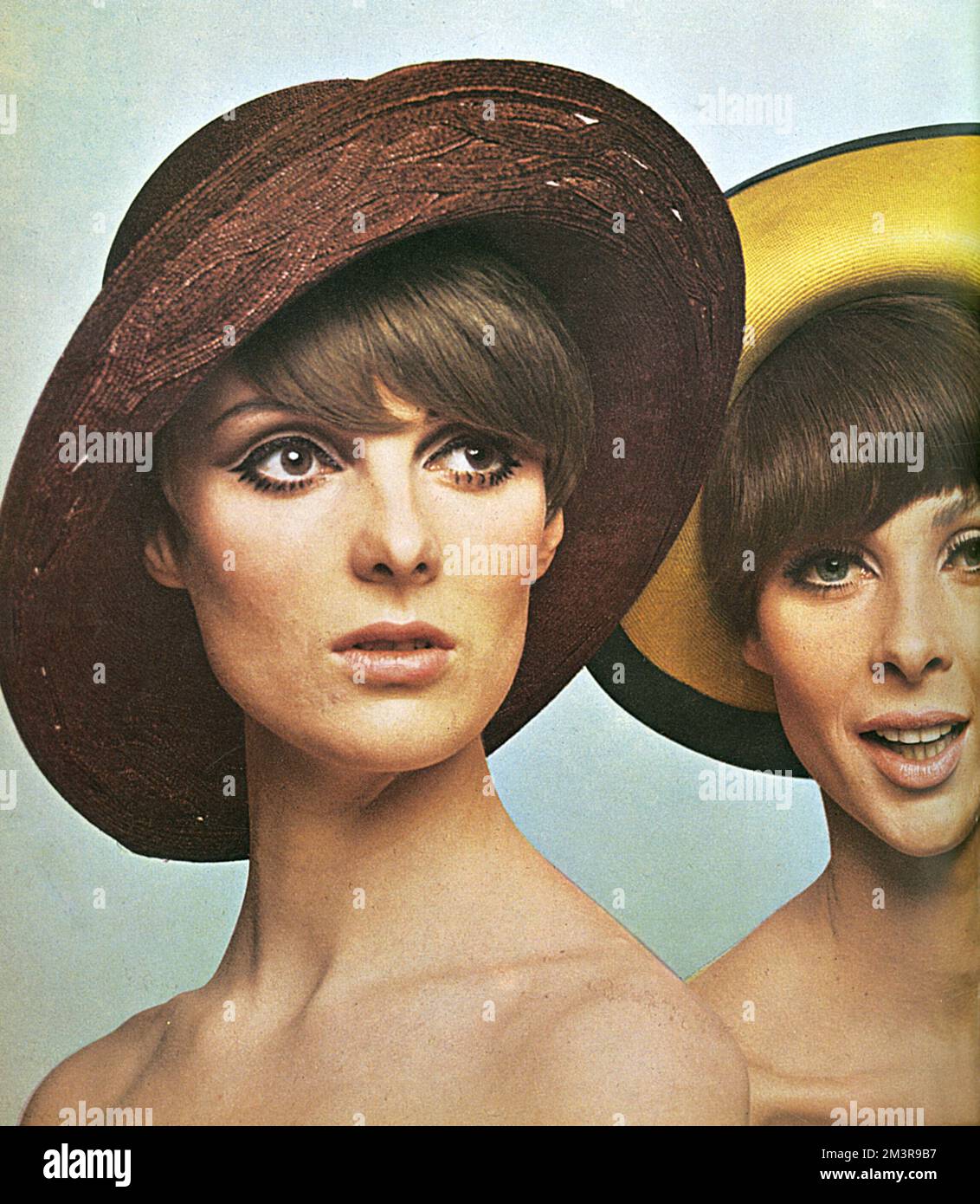 On the left: model wearing a plum straw hat with versatile brim by Otto Lucas Junior. To give her that natural, glowing look, they used the liquid film foundation &quot;Beige Rose&quot; and same shade powder (Ayer Pink No. 1) on cheeks, and &quot;Beige Gazelle&quot; lipstick. For the eyes, black eyeliner used with Super Long mascara, brown eyebrow pencil and &quot;Pearly Beige&quot; eyeshadow.  On the right: model wearing a yellow straw hat with upturned brim banded in navy by Chez Elle. Worn with make-up by Max Factor. The foundation is Sheer Genius &quot;Tempting Touch&quot; under &quot;Tran Stock Photo