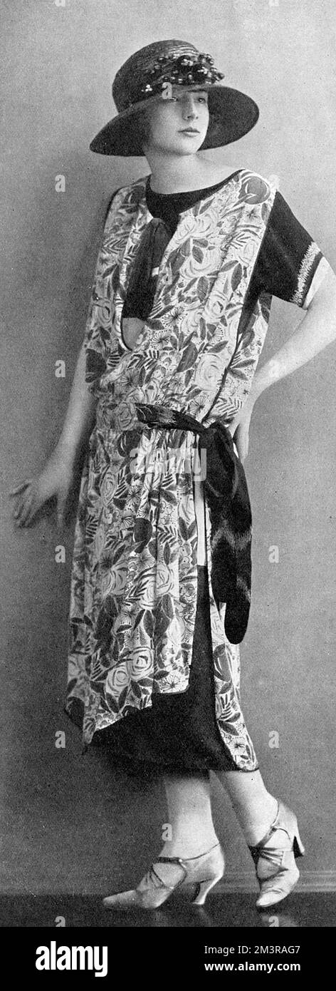 An Ascot frock from the salon of Ernest and Redfern of Albemarle Street, London.  The fourreau is of black satin, the overdress being of black and white foulard marocain.  Touches of red are introduced with 'the utmost discretion.' Stock Photo