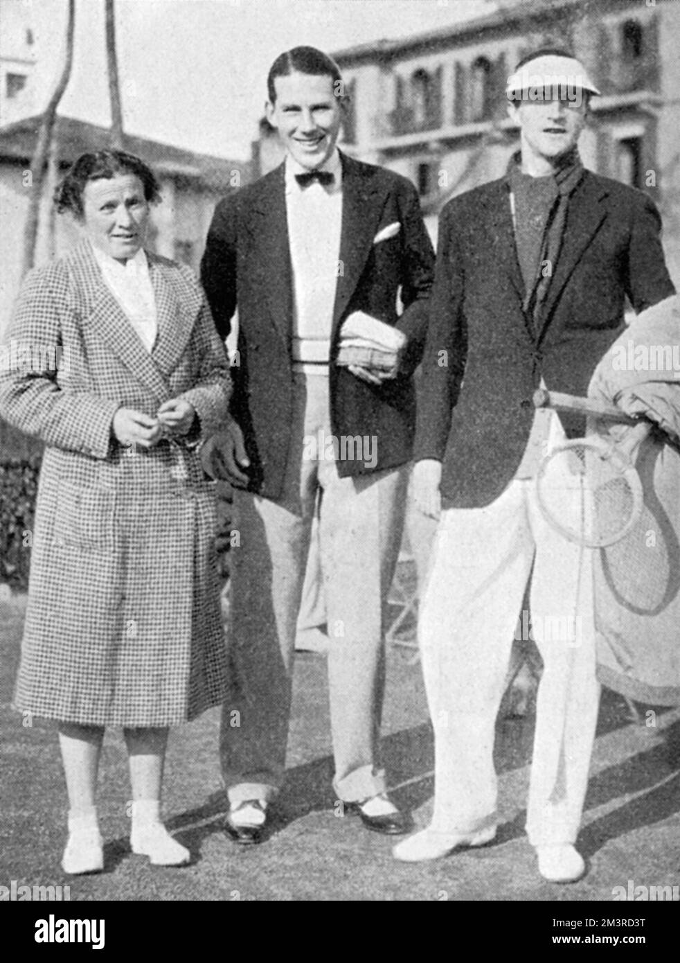 Cuthbert Collingwood &quot;Ted&quot; Tinling (1910-1990) - English tennis player and fashion designer pictured with Miss Ryan and Lord Charles Hope on the tennis courts at Cannes on the French Riviera.  The Tatler at this point describe Tinling as the, 'well-known lawn tennis referee.'     Date: 1931 Stock Photo