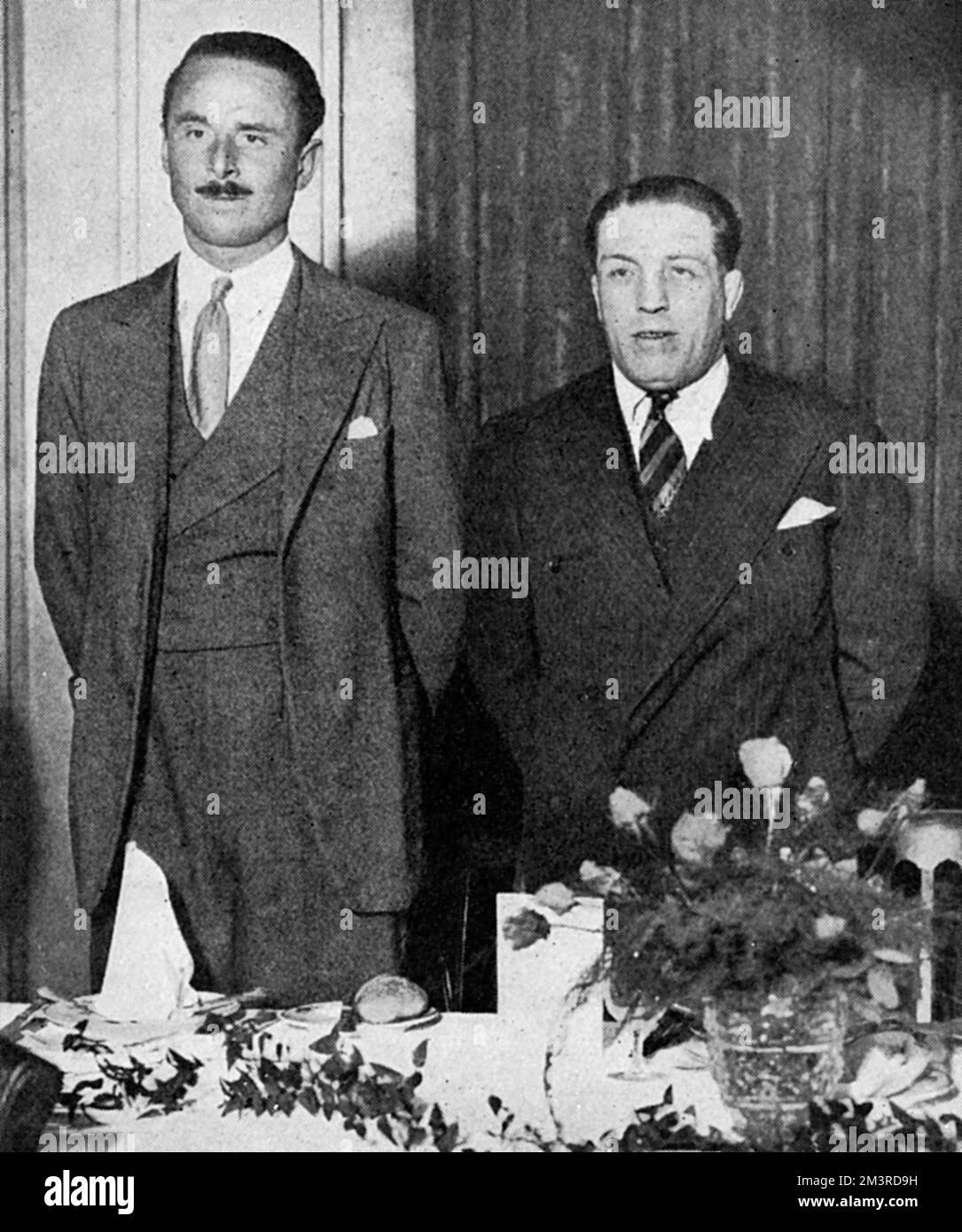 Kid Lewis, triple boxing champion and ex-holder of the world welterweight title who stood as a New Party candidate in Whitechapel, East London.  Pictured posing with the New Party leader, Sir Oswald Mosley at a luncheon given at the Caf&#x9812;oyal where Mosley and Lewis outlined a club movement in which sport and politics were to play a prominent part. The New Party, formed by Oswald Mosley, was a political party formed in 1931 after Mosley resigned from the Labour party. Based on the 'Mosley Memorandum', the Party sought to establish a national policy to meet the economic crisis brought abou Stock Photo