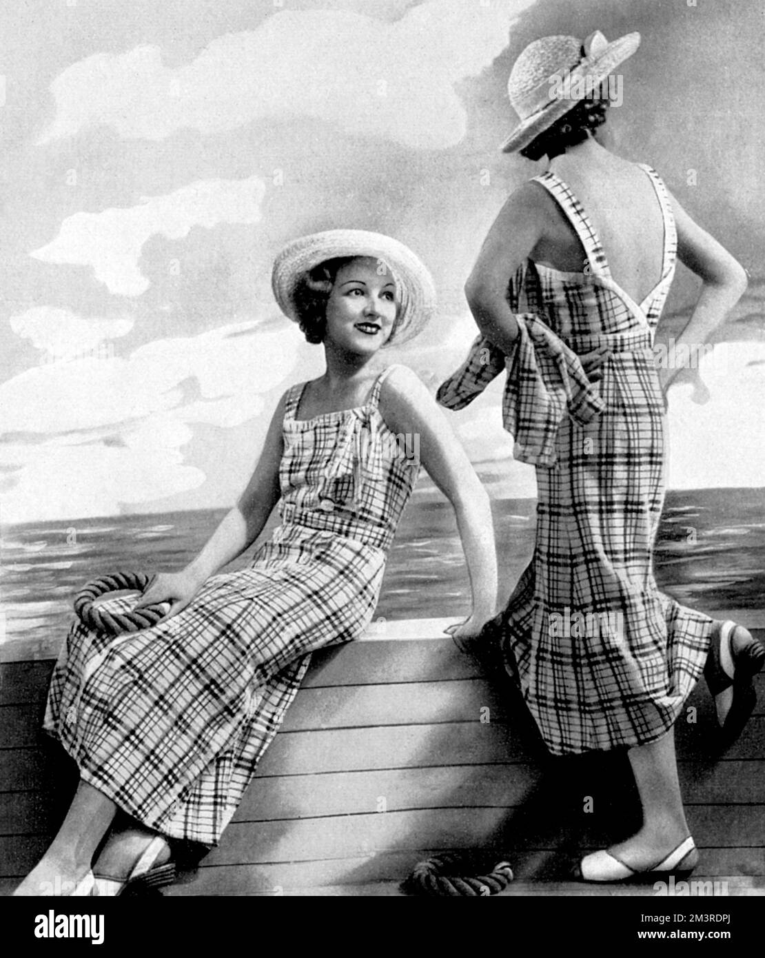 Two views of a backless sun dress in uncrushable cotton showing a broken plaid and check design in a variety of pastel colours, worn with a snappy little coat.  1934 Stock Photo