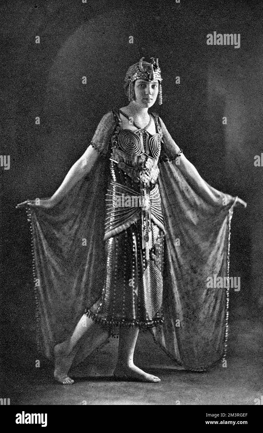 Mary Henniker-Heaton, debutante daughter of  Sir John and Lady Henniker-Heaton, photographed in a fancy dress costume that won her first prize at one of the Monte Carlo fancy dress balls.  Topically, considering recent archaeological discoveries, she is dressed as 'Egypt' in a costume The Sketch describes as being in dull green and gold.       Date: 1923 Stock Photo