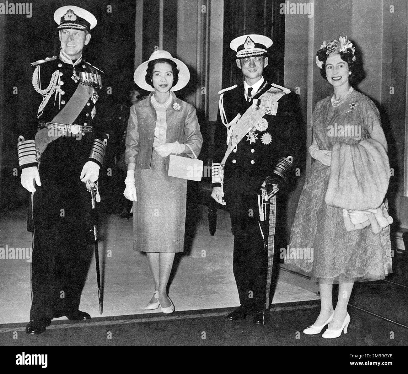 An official two-day state visit to the UK by King Bhumibol Adulyadej (Rama IX) (1927-) and Queen Sirikit (1932-) of Thailand - pose for the cameras at Victoria Station with Queen Elizabeth II (1926-) and the Duke of Edinburgh (1921-).     Date: 1960 Stock Photo