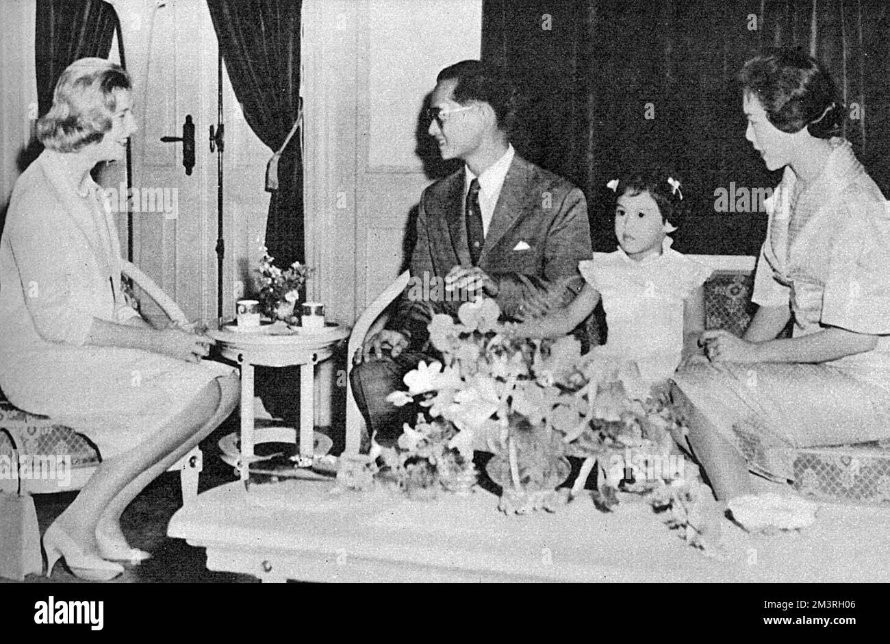 An official state visit to Thailand by Princess Alexandra of Kent (1926-) - pictured with  King Bhumibol Adulyadej (Rama IX) (1927-) and Queen Sirikit (1932-) of Thailand with their eldest daughter Princess Ubolratana Rajakanya (1951-) at the Chitlada Palace in Bangkok.     Date: 1959 Stock Photo