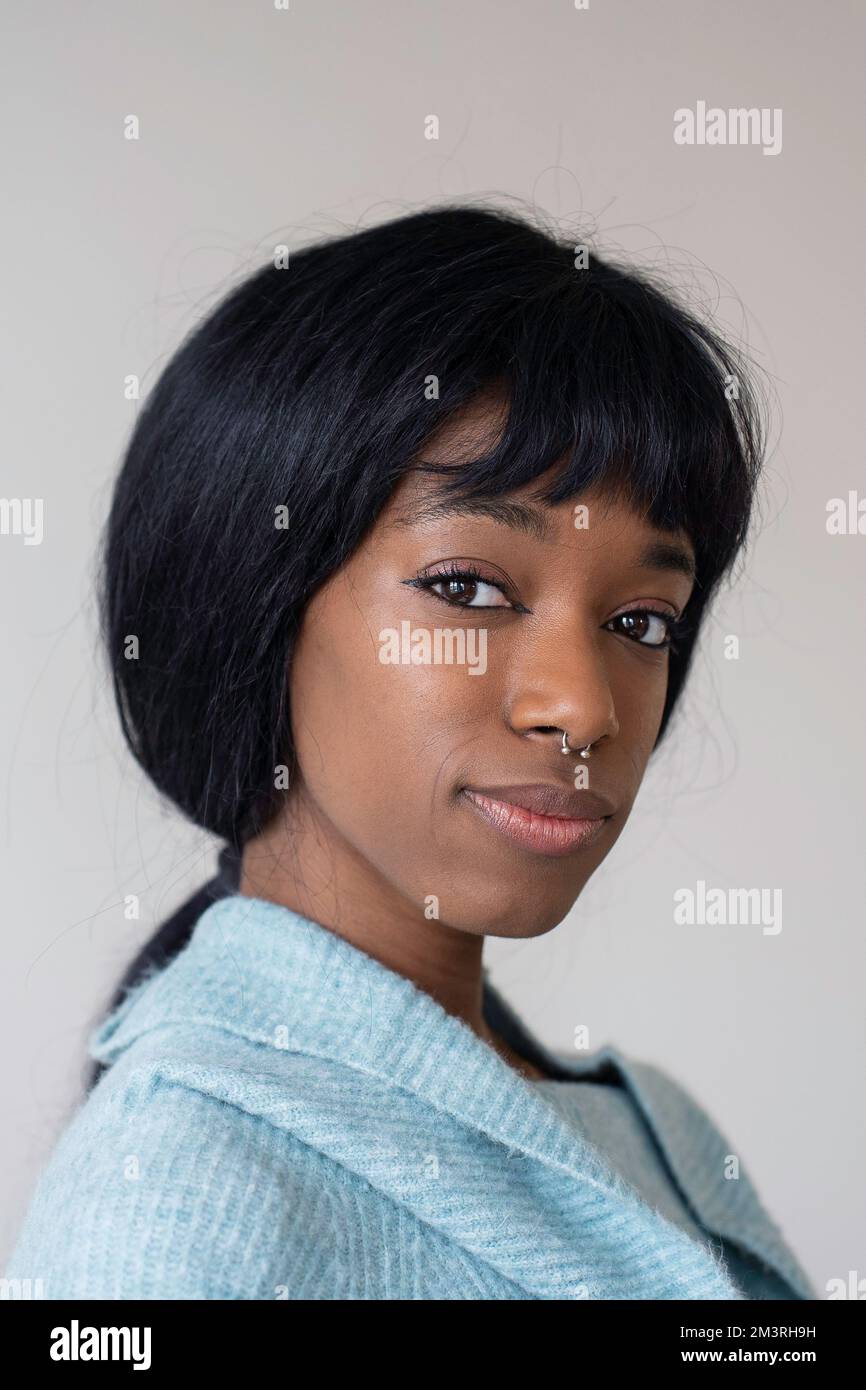 Young black african american woman with a straight hair looking at ...