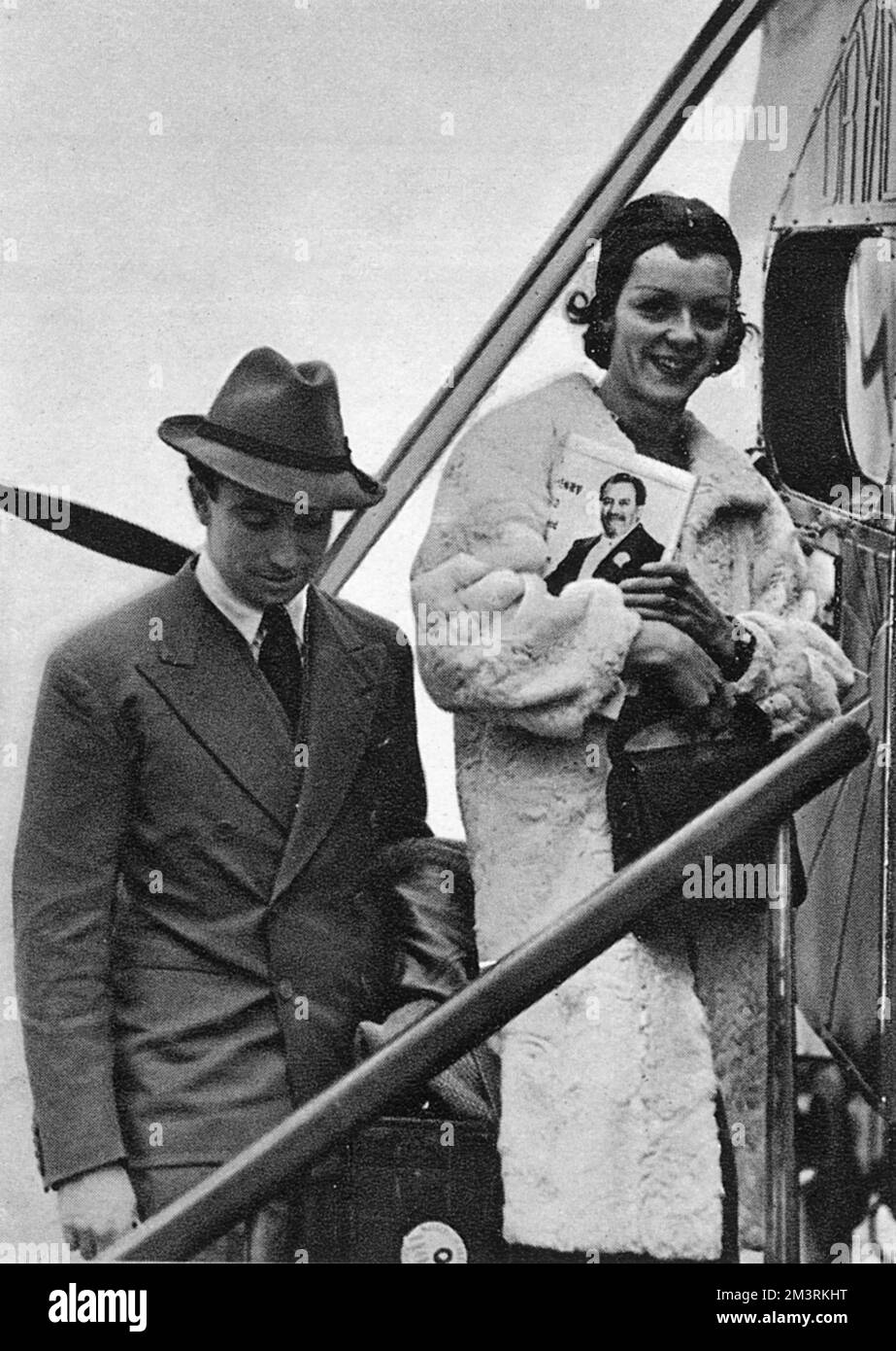 Billy Fiske, bobsled champion and well-known Cresta rider and Rose, Countess of Warwick (formerly Rose Bingham) pictured flying to France for their honeymoon after marrying in Maidenhead in 1938.     Date: 1938 Stock Photo