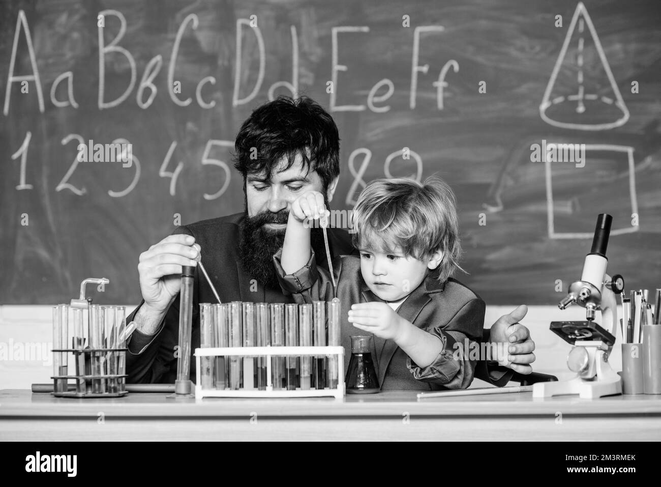 Know How. laboratory research and development. teacher man with little