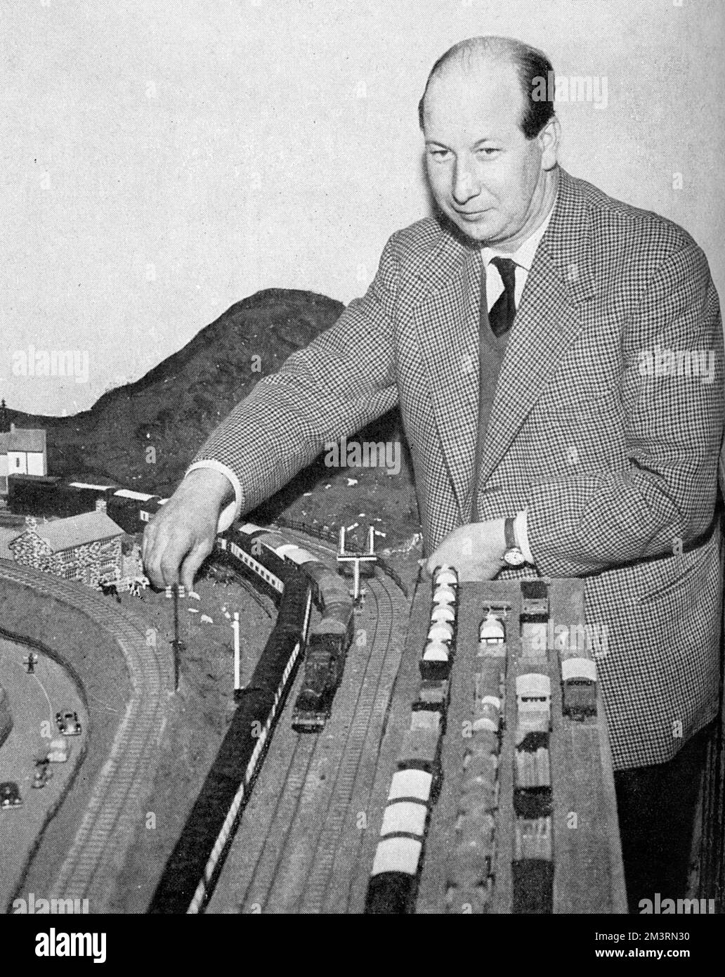 Denis Anthony Brian Butler, 9th Earl of Lanesborough (28 October 1918  27 December 1998), Irish aristocrat pictured with the large model-railway he had set up in his home, Swithland Hall.  A railway enthusiast, he applied to British Rail to be a train driver but was unsuccessful!       Date: 1958 Stock Photo