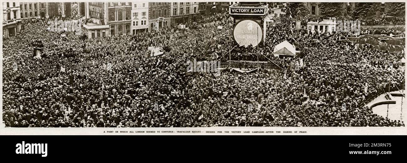 Crowds at Trafalgar Square, decked for the Victory Loan Campaign, after signing of the Treaty at Versailles.  1919 Stock Photo