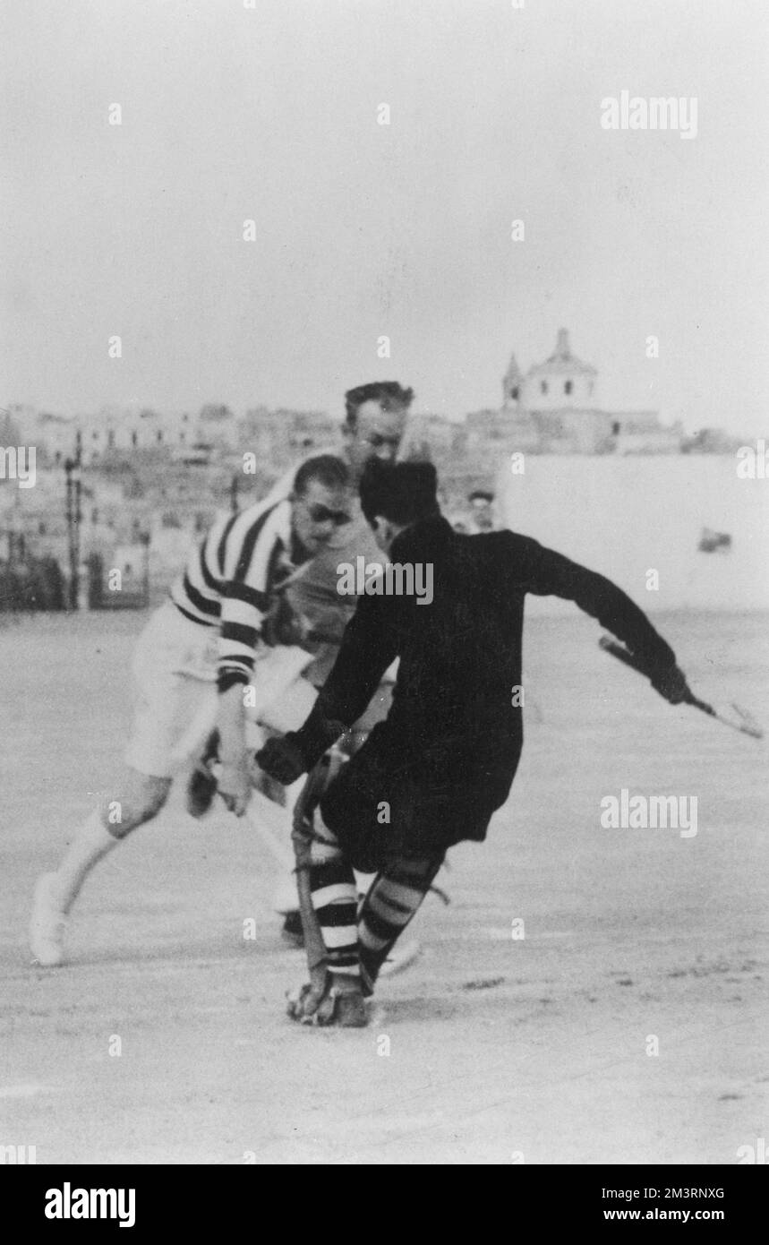 Prince Philip, Duke of Edinburgh (wearing dark glasses) pictured in action in the midst of a hockey match in which his ship, HMS Chequers, took on HMS Forth in Malta.       Date: 1950 Stock Photo