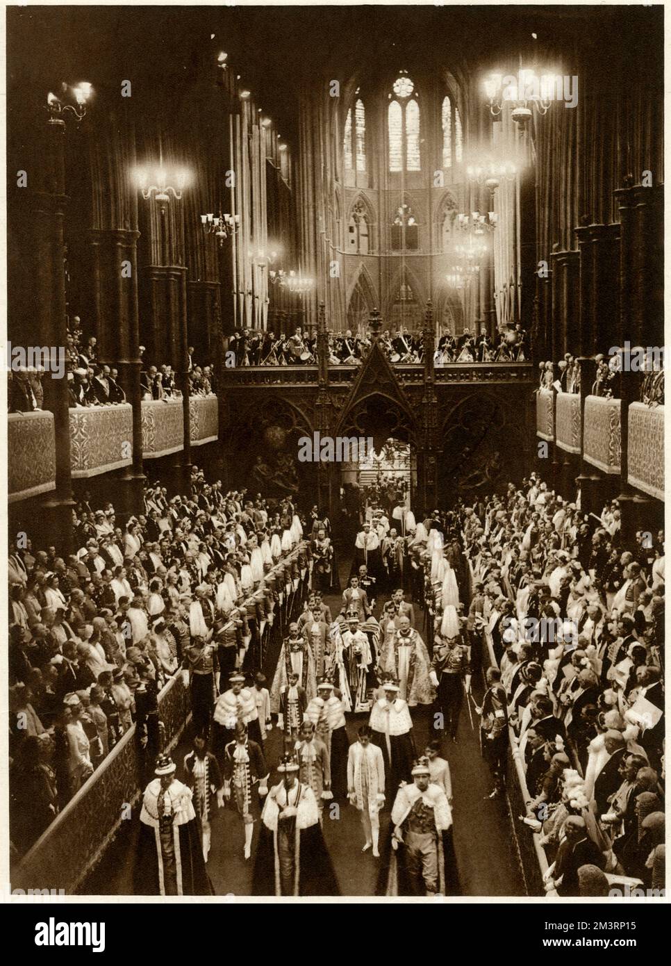 King George VI leaves Westminister Abbey after being crowned. The King's procession is passing through th Choir to the West Door. In the foreground are the Lord High Constable of England (Lord Crewe), Lord Zetland, carrying the Sword of State, and the Earl Marshal (the Duke of Norfolk), followed by their pages. The King is accompanied by the Bishop of Durham and of the Bath and Wells, escorted by the Lieutenant with ten Gentlemen Arms and Standard Bearer.     Date: 12 May 1937 Stock Photo