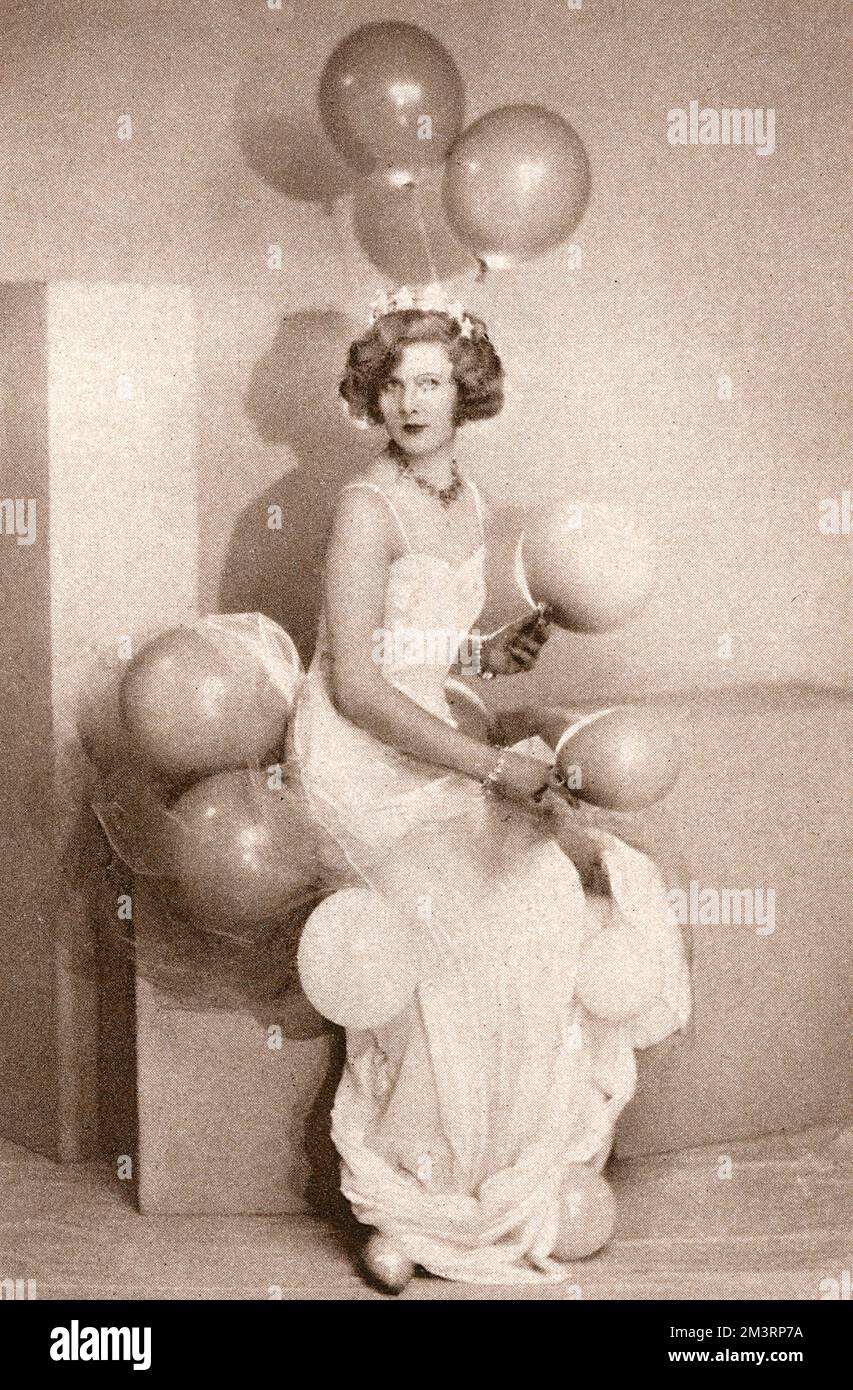 Black and white photograph of Miss Nancy Beaton in her 'Air' dress for the Tha Ball of the Midnight Sun organised by Mrs Robin d'Erlanger at the Park Lane Hotel, London on 22nd November 1928. Miss Beaton's costume - which consisted mainly of balloons - was designed by her brother Cecil Beaton.      Date: 21st November 1928 Stock Photo