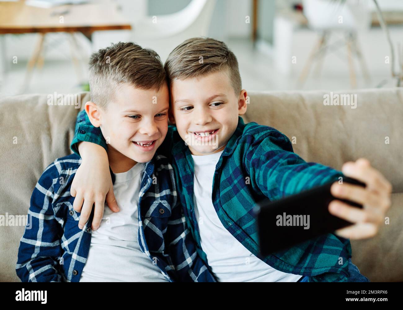 child brother friend having fun taking selfie mobile phone technology smartphone happy kid Stock Photo