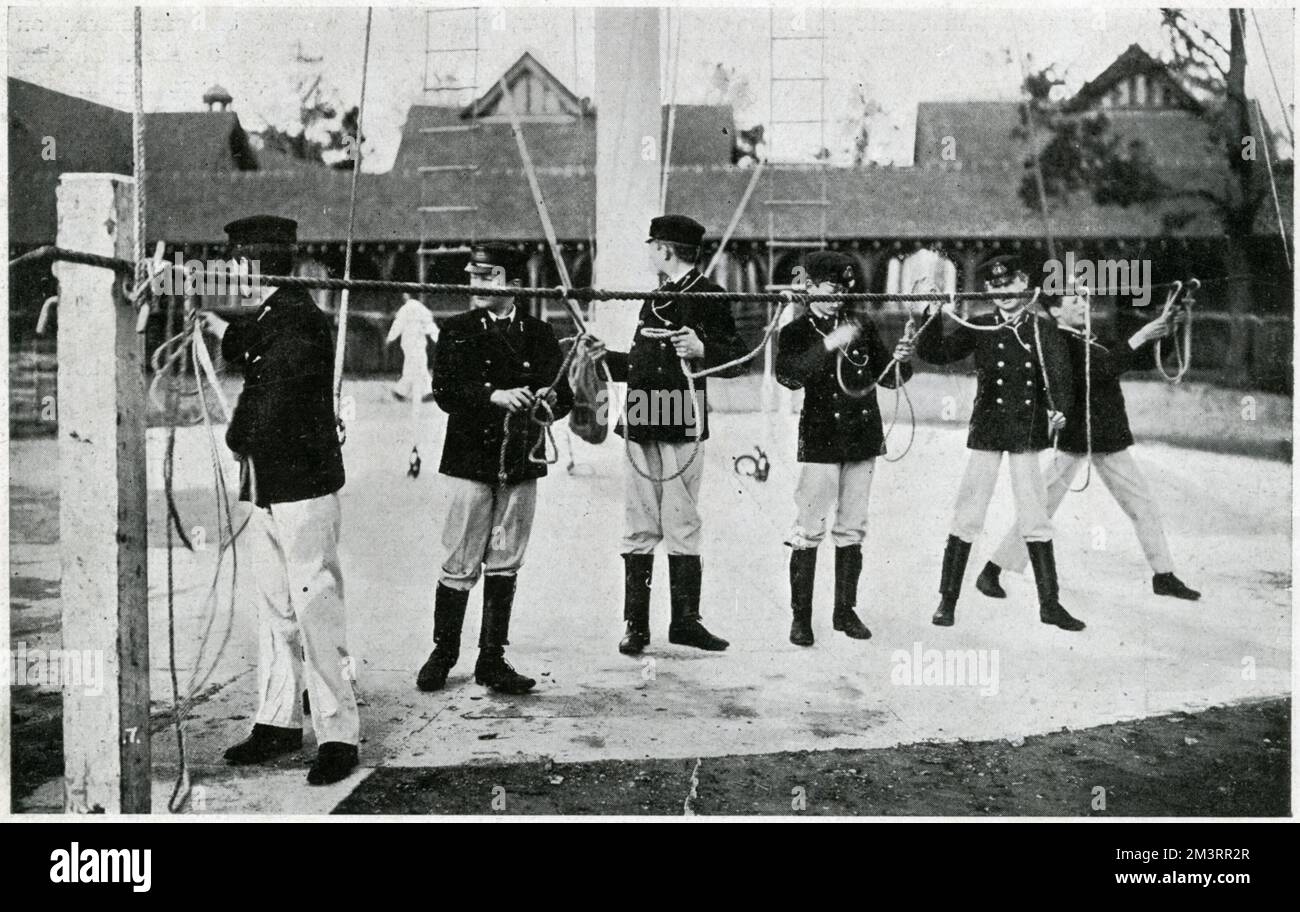 In 1903, part of the estate, the Stable Block being the hub, became a junior officer training college for the Royal Navy known as the Royal Naval College, Osborne, initial training began at the age of 13. Photograph showing the rope-splicing drill.     Date: 1905 Stock Photo