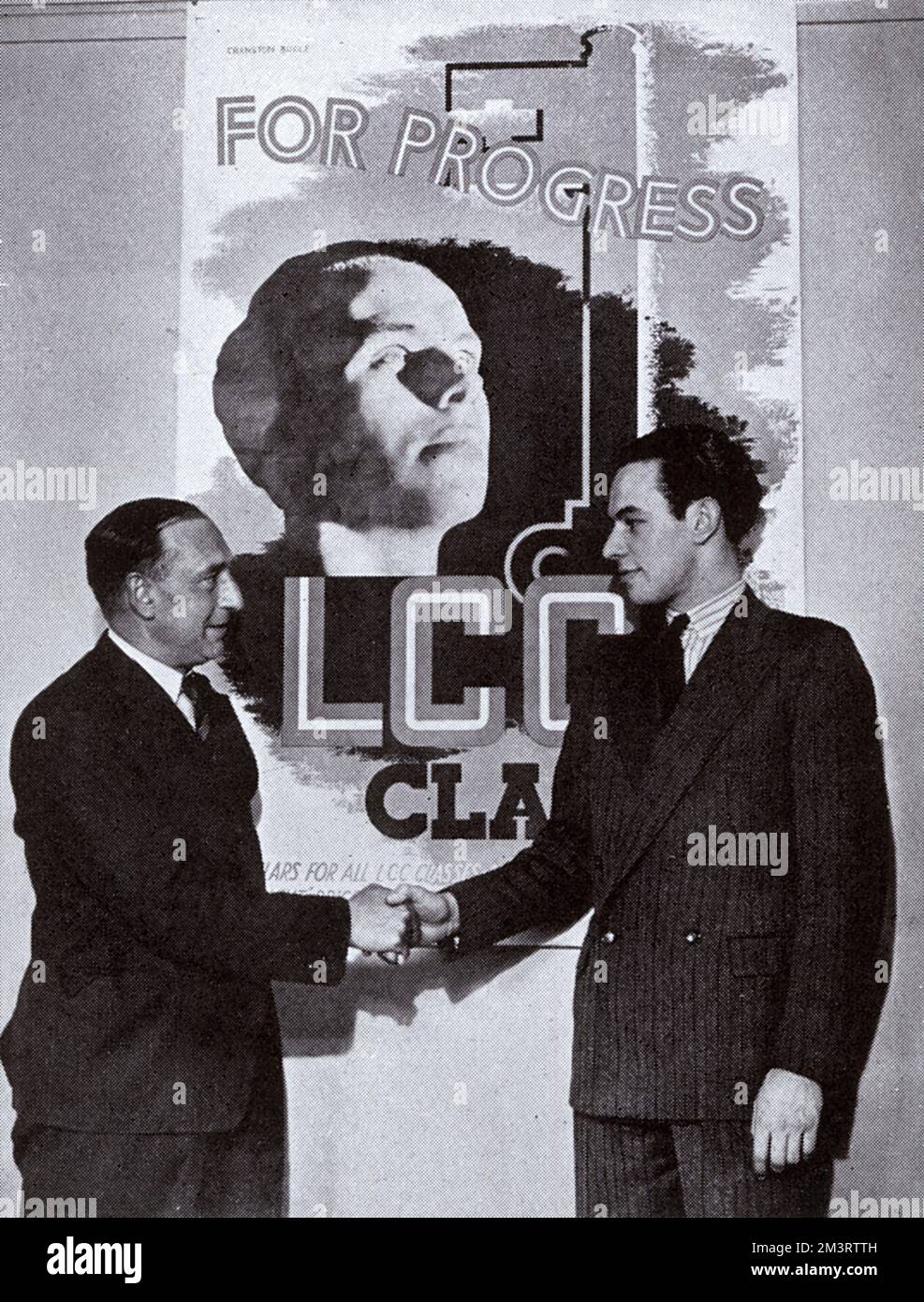 G. Cranston Bogle, a young Yorkshire artist, receiving his prize for designing a poster to promote evening classes run by London County Council.  He won the 50 prize over 800 entries.  He had just left Bradford College of Arts and Crafts and begun work as a designer for a London publishing firm.  Pictured shaking hands with L. Hertel, the publicity officer for the LCC evening classes, with his winning design in the background.  The young man in the picture was George Bogle, father of Nigel Bogle, founder of the advertising agency Bartle Bogle Hegarty.  George was also an adman and implemented Stock Photo