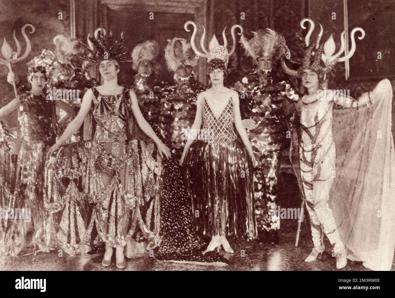A group on the theme of 'Neptune's Embassy' at Baroness D'Erlanger's celebrated costume ball at the Fenice Theatre, Venice in 1926.  From left, Princess de Faucigny-Lucigne (Baba D'Erlanger) as water, Viscountess Wimborne as the earth, Mrs Evelyn Fitzgerald as seaweed and Comtesse de Buccino as coral.  Several tritons form the back row!     Date: 1926 Stock Photo