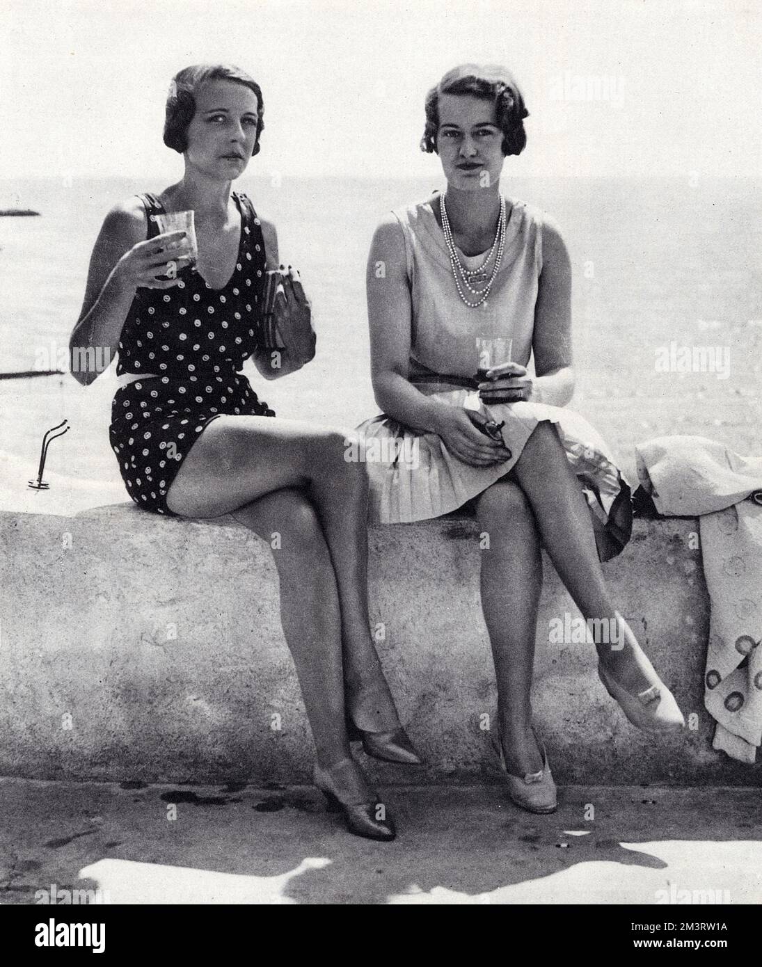 The Marquise de Casa Maury, formerly Miss Paula Gellibrand, and Mrs Loel Guinness, formerly Joan Yarde-Buller, daughter of Lord Churston.  Joan later divorced her husband and married Prince Aly Khan.  The pair are pictured at the fashionable sunbathing resort of Eden Roc on the French Riviera.  1929 Stock Photo