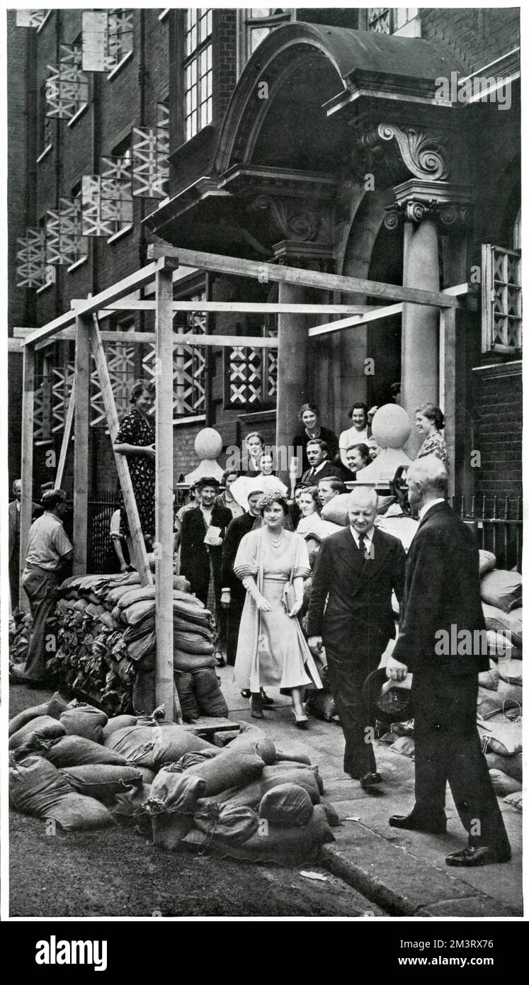 Queen Elizabeth (later the Queen Mother) pictured visiting the Vincent Square Infants' Hospital in Victoria, London, just before the declaration of war in September 1939.  Note the taped windows and sandbags already in use as a precaution against air raids.     Date: 1939 Stock Photo