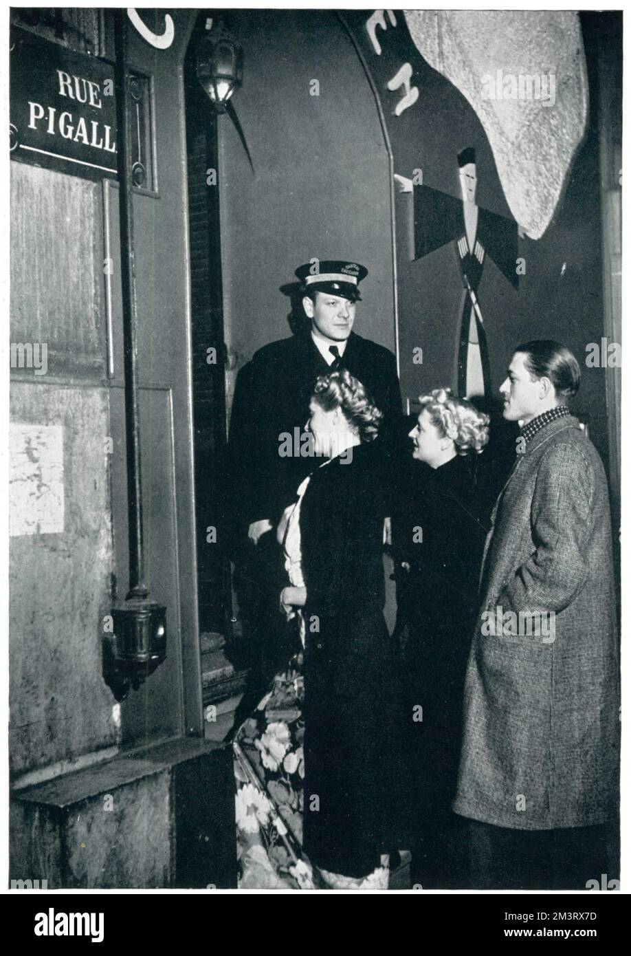 Arriving at the cabaret, 'Le Caveau Caucasien' (a venue kept by White Russians) in Montmartre, Paris, in the opening weeks of the Second World War.       Date: 1939 Stock Photo