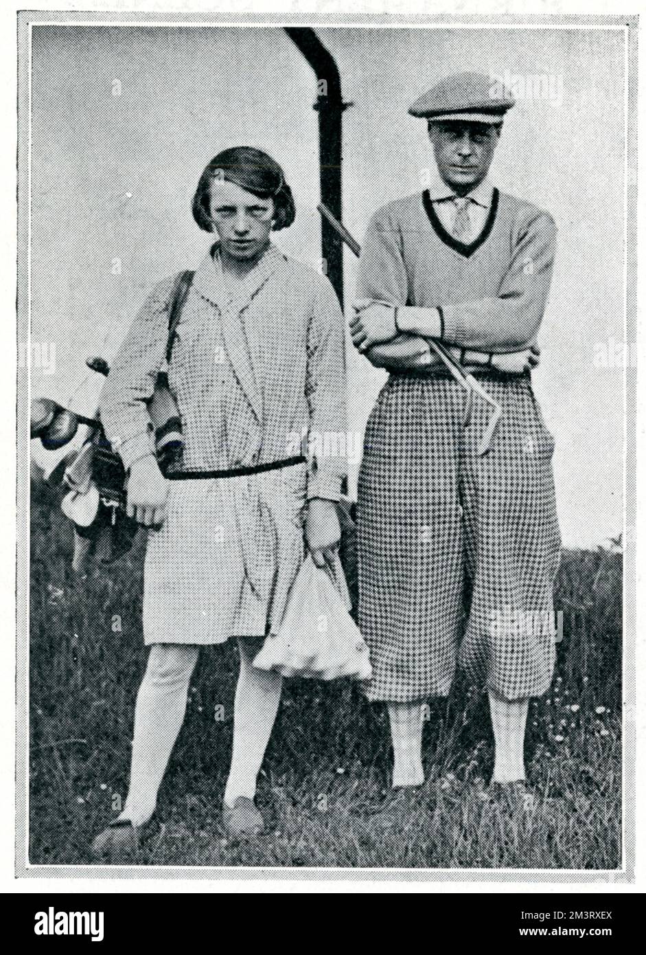 The Prince of Wales, later King Edward VIII, then Duke of Windsor, pictured at fashionable French resort, Le Touquet in 1930 with his favourite girl caddy, Adolphine Lamour.  Le Touquet's golf course was famous for employing young, female caddies.   On this occasion the Prince took part in the Turf Club handicap tournament, in which he was beaten by Colonel R. E. Myddelton, of Chrik Castle, North Wales.        Date: 1930 Stock Photo