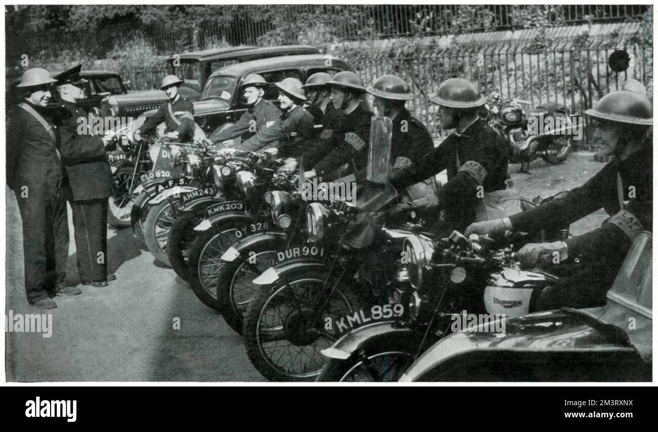 A line of dispatch riders attached to the Auxiliary Fire Brigade in September 1939. Among the riders is Nobby Key - a famous speedway rider who competed for Crystal Palace and New Cross (1929 - 36).     Date: 1939 Stock Photo