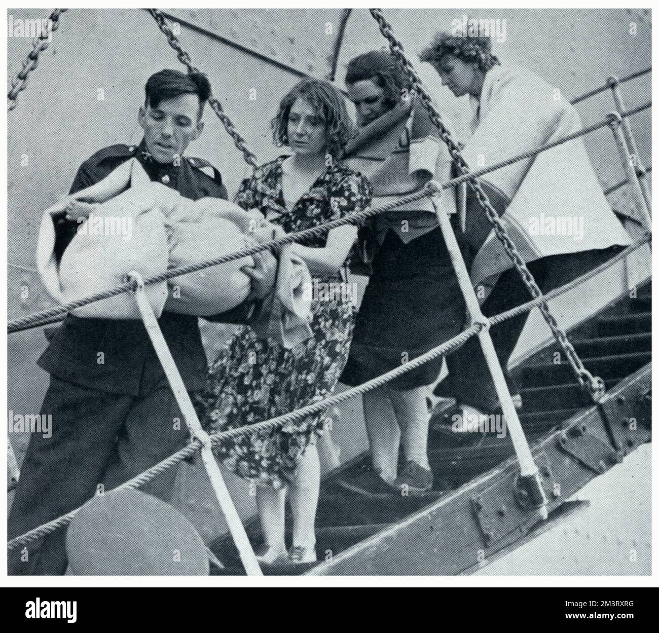 A sailor carries a baby wrapped in a blanket off the Norwegian vessel &quot;Knute Nelson&quot;, followed by three female survivors from the Athenia, having been sunk by German torpedoes.   September 1939 Stock Photo