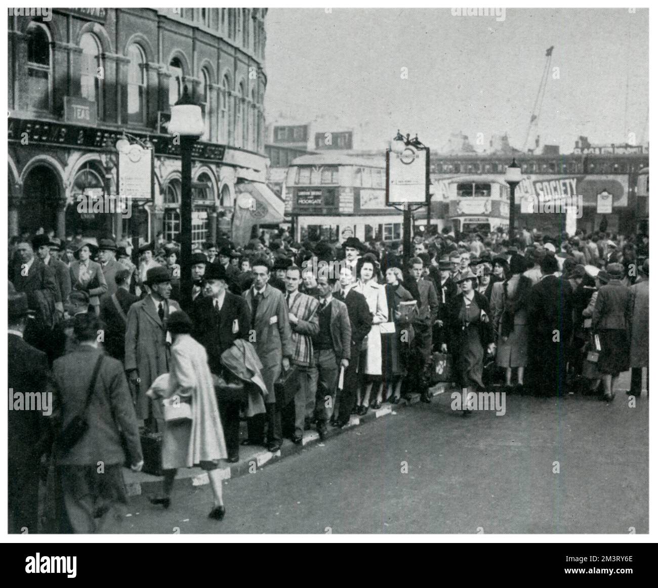 Heavy queues in London due to reduced bus services to save fuel in times of spirit rationing, particularly in the mornings as people made their way to work. By 1940 over 800 buses from Central London were unused yet a reduction in travelling as a result of the war, evacuation of children and the deployment of most adult men abroad ensured that passenger traffic remained manageable.      Date: 1939 Stock Photo